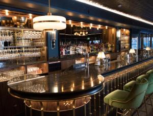 a bar with a large table and chairs at Hotel Rival in Stockholm