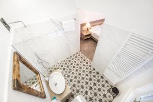 an overhead view of a bathroom with a toilet and a bed at OH Apartments & Rooms in Ljubljana