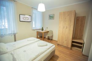 a bedroom with a bed and a table in it at Dom Nad Wodospadem in Miedzygorze