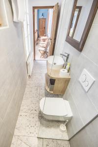 a bathroom with a toilet and a sink at OH Apartments & Rooms in Ljubljana