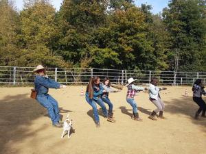 a group of children playing with a dog in the dirt at Agridomus il Mulino in Palazzo del Pero