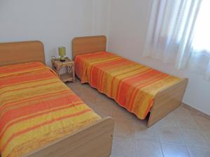 Postel nebo postele na pokoji v ubytování Residence della Torre Isola Rossa