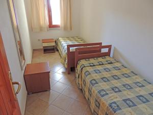 Postel nebo postele na pokoji v ubytování Residence della Torre Isola Rossa