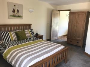 A bed or beds in a room at Weatherhead Farm