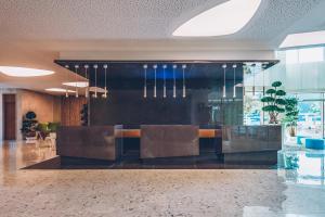 a lobby with chairs and a bar in a building at Carine Hotel Kumbor Superior in Herceg-Novi