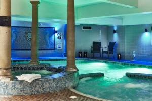a large swimming pool with a large tub at Bournemouth West Cliff Hotel in Bournemouth