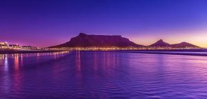 a large body of water with a mountain in the background at Lagoon Beach Hotel & Spa in Cape Town