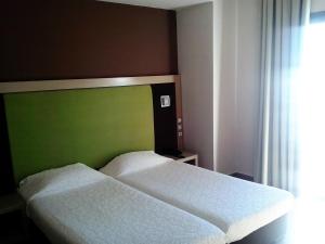 Postel nebo postele na pokoji v ubytování Hotel Kipseli