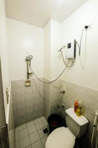 a small bathroom with a toilet and a shower at Bing's Place in Manila