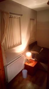 a bedroom with a bed and a lamp on a table at Mountjoy House in Derry Londonderry