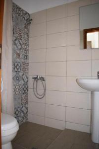 a bathroom with a toilet and a sink at Eleni's House Skiathos in Skiathos +51 photos