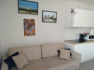 a living room with a couch and some pictures on the wall at U Lotnika in Szlachtowa