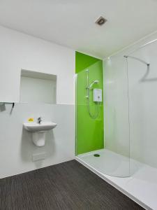 a bathroom with a shower and a sink at Lost Guest House Stirling in Stirling