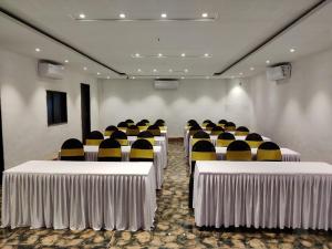a conference room with rows of tables and chairs at Hill Forest Resort in Lonavala