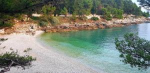 a view of a river with a rocky shore at Apartmani Val in Pula