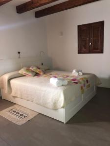 Ein Bett oder Betten in einem Zimmer der Unterkunft Casa S'Olibassa