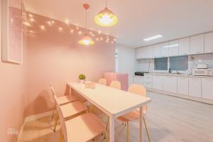a kitchen and dining room with a table and chairs at SeeU House Hongdae in Seoul