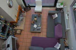 an overhead view of a living room with a purple couch at Theo Pool Villa Magnificent Sea View in Kapandrítion