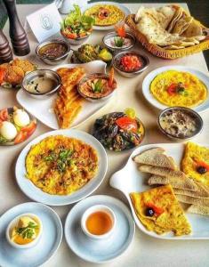 a table with many plates of food on it at King Nubian guest house in Aswan