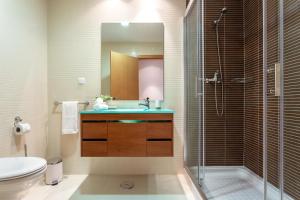 a bathroom with a shower and a sink and a toilet at Privilege Apartment Galichet with Rooftop Pool, Village Marina - Olhão in Olhão +15 photos