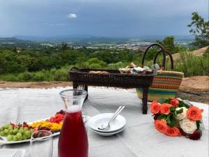 a table with a plate of food and a piano at Calla Lily Guesthouse in Nelspruit