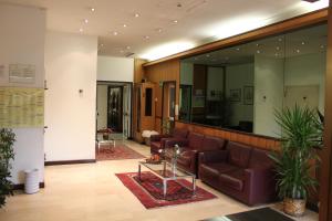 a lobby with a couch and a table at Hotel Fortuna in Ancona