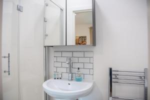 a bathroom with a sink and a mirror at Executive House in Ipswich