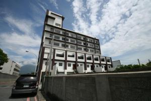 a car is parked in front of a building at Fair Tale Motel - Sea in Hualien City