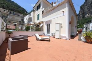 a patio with a couch and a building at Palazzo Gargano Amalfi in Amalfi