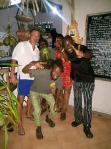 a group of people posing for a picture at Mbuyuni Beach Village in Jambiani