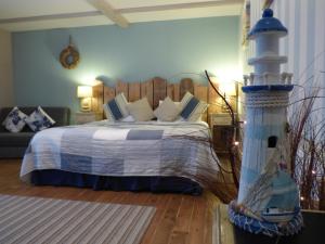 a bedroom with a bed and a lighthouse in it at The Cross Guest House in Mablethorpe