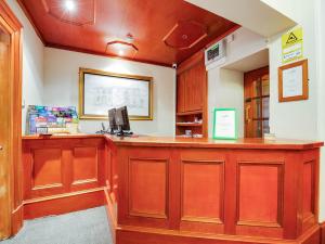 a lobby with a large wooden bar in a room at Lost Guest House Stirling in Stirling