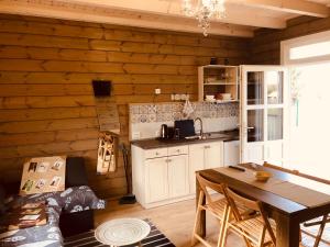 a kitchen with a wooden wall with a table at Club Thermal Village Cegled in Cegléd