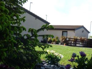 a house with a yard with flowers and plants at The Cross Guest House in Mablethorpe