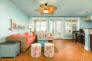 a living room with a couch and a ceiling fan at Sandpiper Point in Galveston