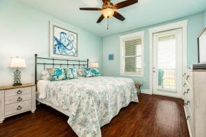 a bedroom with a bed and a ceiling fan at Sandpiper Point in Galveston