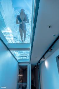 a woman in the water in a swimming pool at Welldone Quality - Crystal pool in Seville