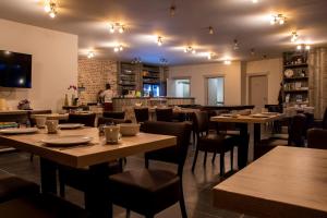 a restaurant with tables and chairs and a person in the background at B&B De Oude Winning in Riemst