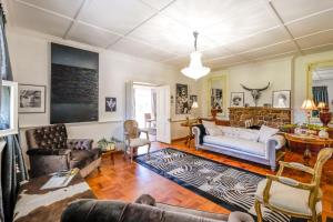 a living room with a couch and a table at No.10 Caledon Street Guest House in George