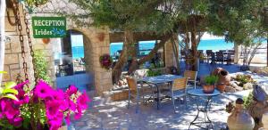 a restaurant with a table and chairs and the ocean at Irides in Souvala