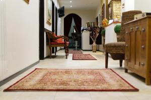 a hallway with two rugs on the floor at B&B Muro Torto Lucera in Lucera