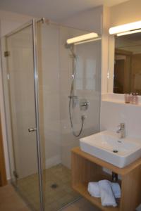 a bathroom with a shower and a sink at Hotel Gasthof Tirolerwirt in Bischofshofen