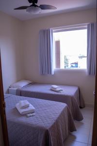 Uma cama ou camas num quarto em Rivello Apart Hotel