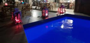 a swimming pool in a restaurant with two red lights at Irides in Souvala