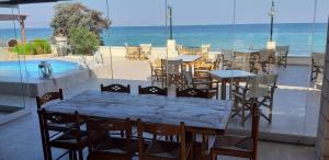 a restaurant with a table and chairs and the ocean at Irides in Souvala