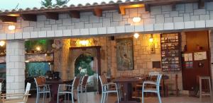 a restaurant with tables and chairs in front of a building at Irides in Souvala