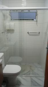 a bathroom with a glass shower with a toilet at POUSADA LOS AMIGOS CAMPECHE in Florianópolis