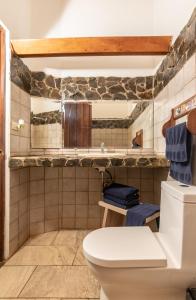 a bathroom with a toilet and a sink at Cabinas Las Olas in Playa Avellana