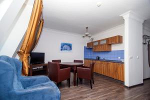 a kitchen and dining room with a table and chairs at Apartamenty Wratislavia in Wrocław