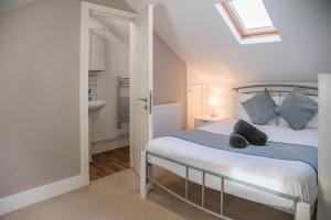 a bedroom with a bed and a bathroom at Executive House in Ipswich